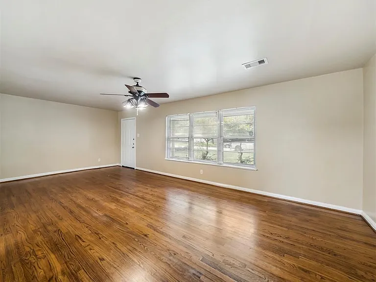 Large family room with original hardwood floors throughout