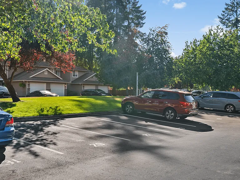 Ample parking and tree-lined surroundings create a welcoming atmosphere at Mountain Park Townhomes.