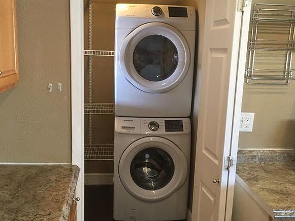 Stackable front loading washer/dryer off the kitchen.