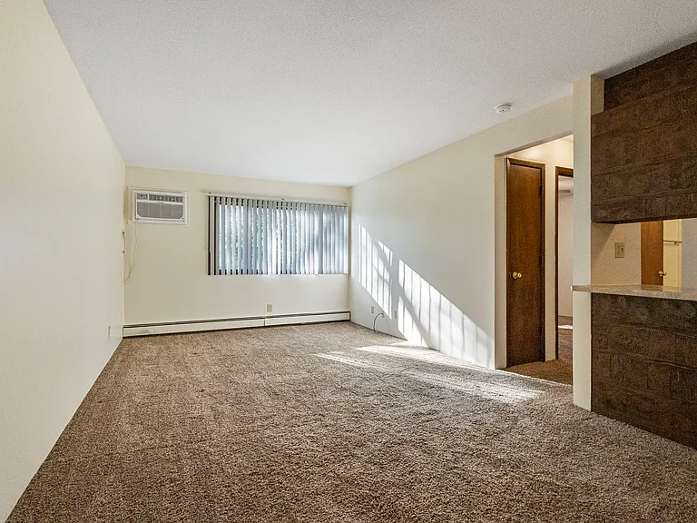 Living room with wall unit air conditioning
