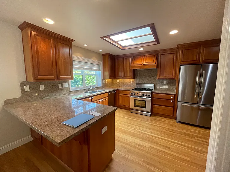 Kitchen-Sun-drenched chef's kitchen featuring an architectural skylight with integrated ambient night lighting.