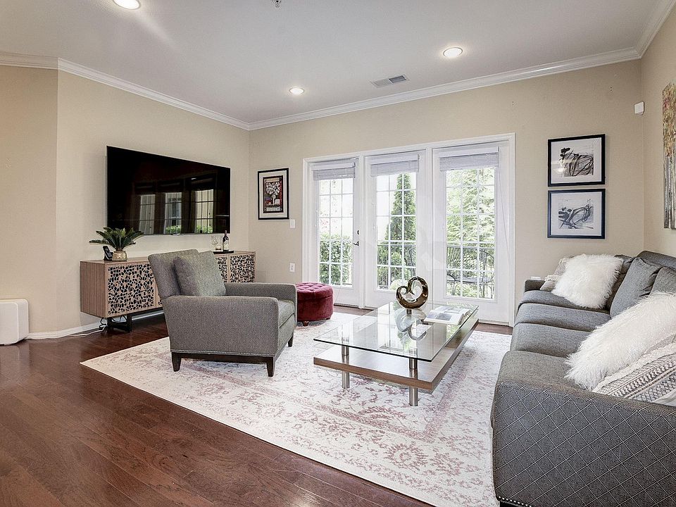 Living area with door to oversized terrace and view of courtyard