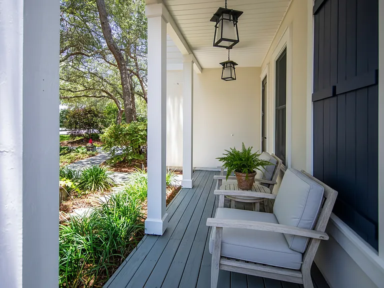 Spacious front porch leading to a quiet street.