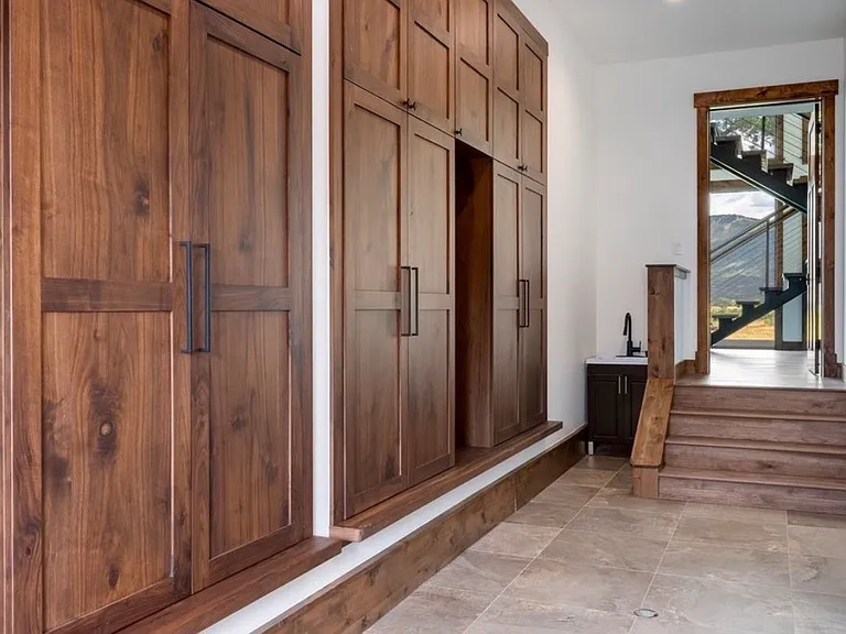 4 floor to ceiling mudroom double door storage cupboards with outlets for storing all your seasonal gear