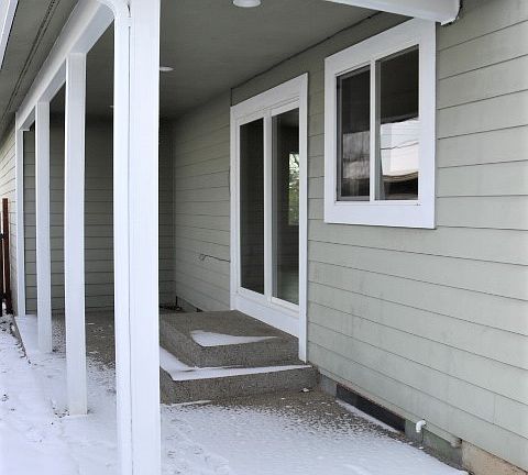 Sliding glass door from kitchen area to a side covered patio.
