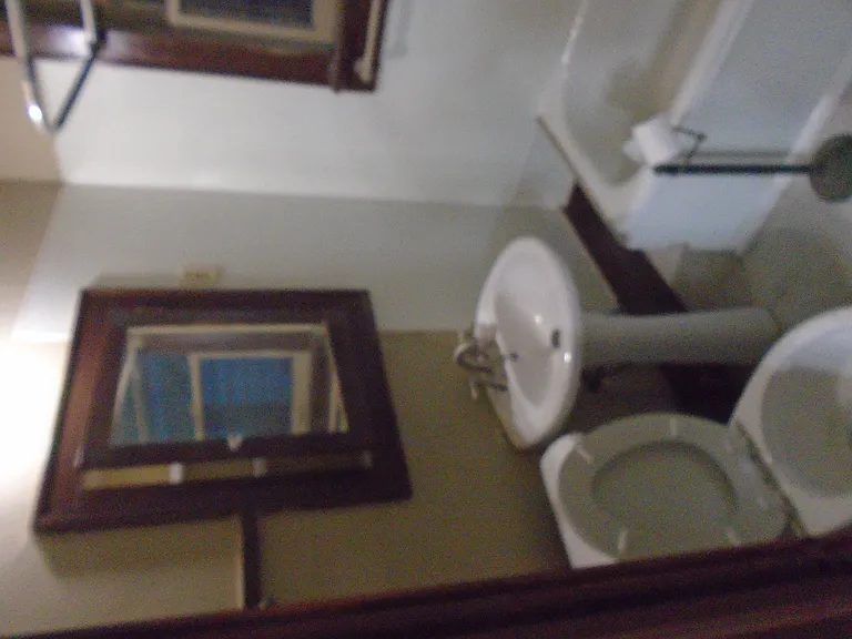 View of the bathroom toilet, with view tilted 90 degrees to the left (sorry)