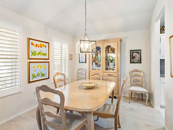 The dining room is off the entryway and adjacent to the kitchen. Look at the beautiful plantation shutters.