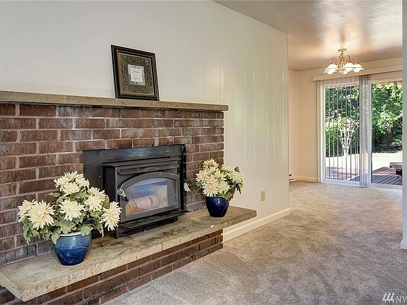 From the living room, enter the dining area and access to the back deck and large yard. 