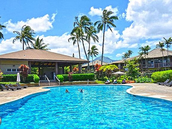 Large community pool w cabana area grill and dining tables