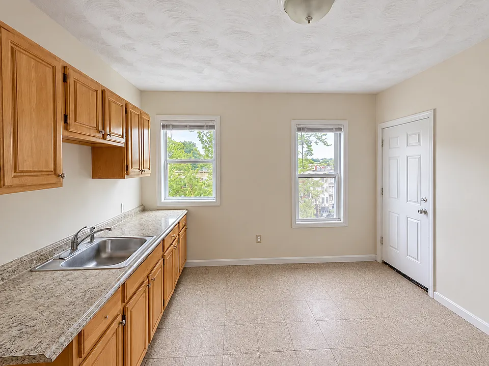 Kitchen with gas range, refrigerator, and microwave _ all appliances included.