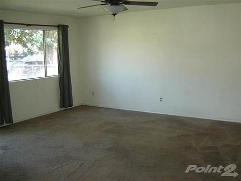 Living room w/ bay window.  Note: Living room ceiling fan & light operate with remote and do not operate on wall switch.