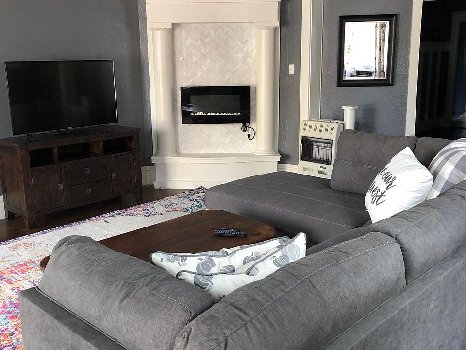 Large living area with electric fireplace and heater