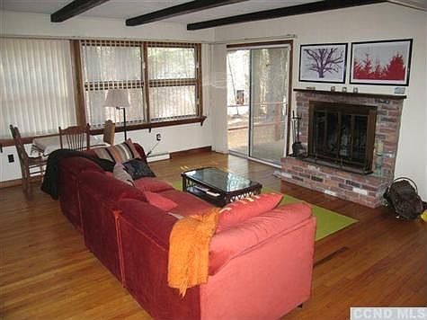 View to wood burning fireplace and door to outside deck