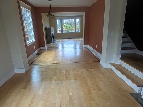 Open, light filled main floor... view from entry, including front room, dining room and living room with fireplace in back