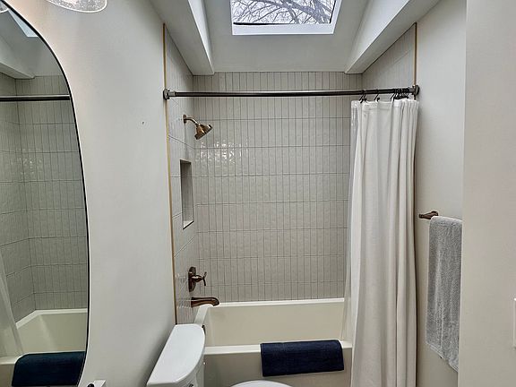 Updated bathroom with a skylight window