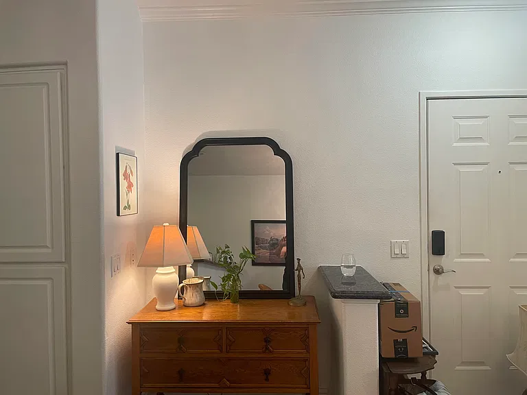 Entry "moment" with storage space.
Kitchen pantry cupboard to the left, front door to the right. Mirror, lamp, and dresser included.