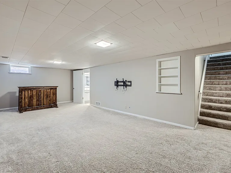 Clean and bright basement with built-in bar