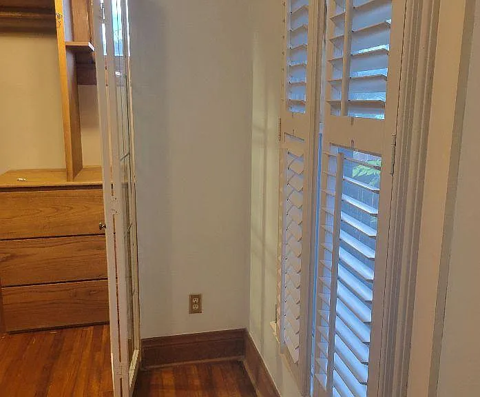 Bedroom #1 has large closet with built-ins, hardwoods, ceiling fan, and plantation shutters.