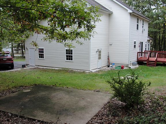House from rear side and concrete barbeque flat