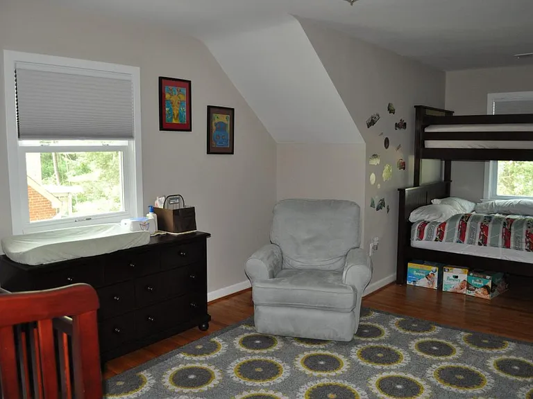 upstairs bedroom with black-out blinds, closet, and large st