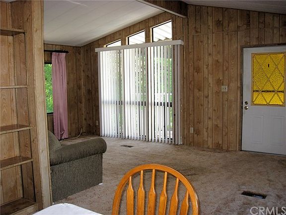 Living area with vaulted ceiling and lots of windows.