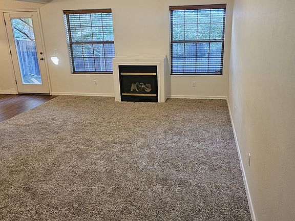 Vaulted ceilings with ceiling fans. Large living room with gas fireplace.