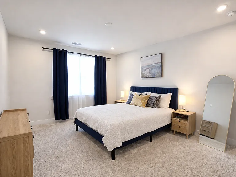 Spacious primary bedroom with large windows