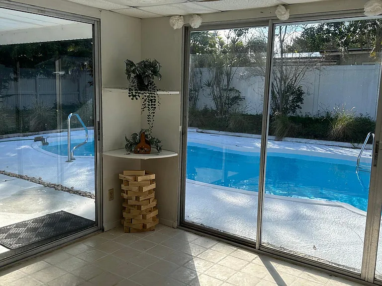 Florida room with pool view