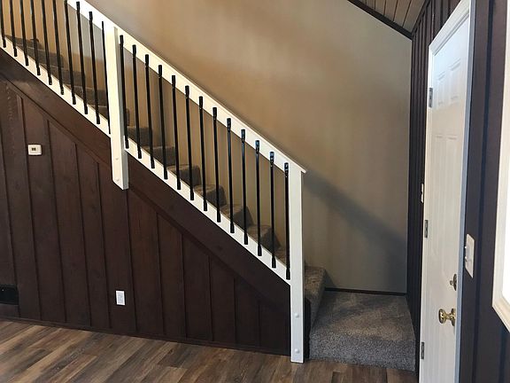 Front door (right) with landing and staircase.