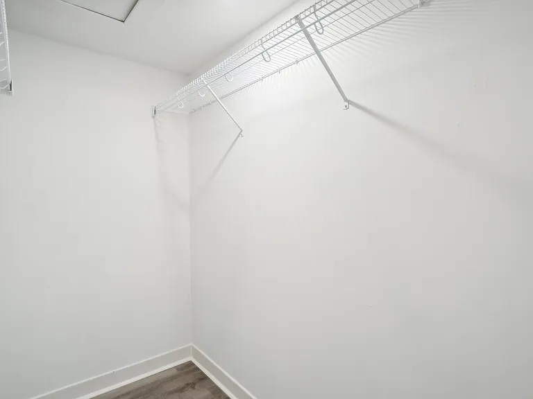 Primary suite walk-in closet
room for dressers below hanging clothes