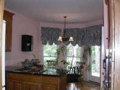 Kitchen with oak floor and marble back splash
