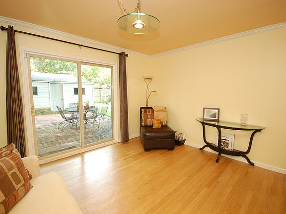 The den also has a sliding door that leads to the backyard brick patio.