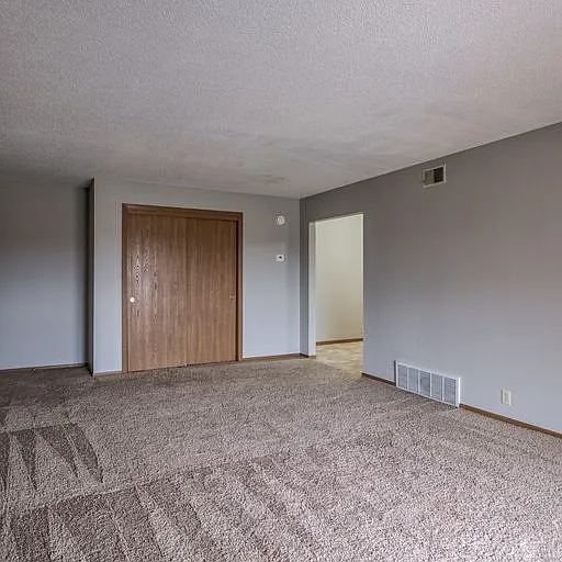 Living room with storage and kitchen entrance at 108 Blondo.