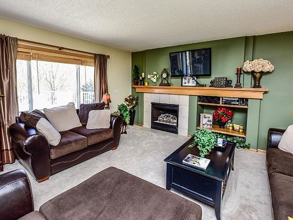 Main floor family room with lots of light, gas fireplace and built in bookcase.