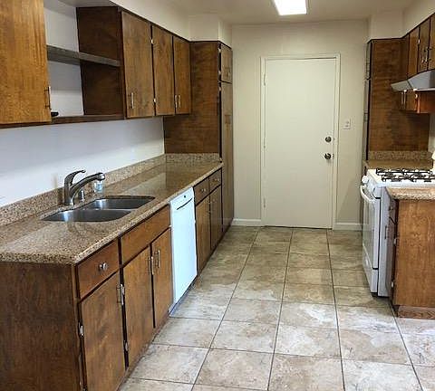Bright kitchen with granite counter top, tile floors, an storage galore, gas stove w/hood, Miele dishwasher, all Led light fixtures.