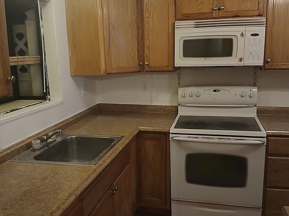 Kitchen with microwave and electric stove.
