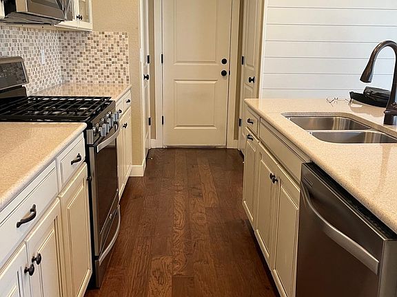 Main Floor: Kitchen view, access to pantry, garage and basement