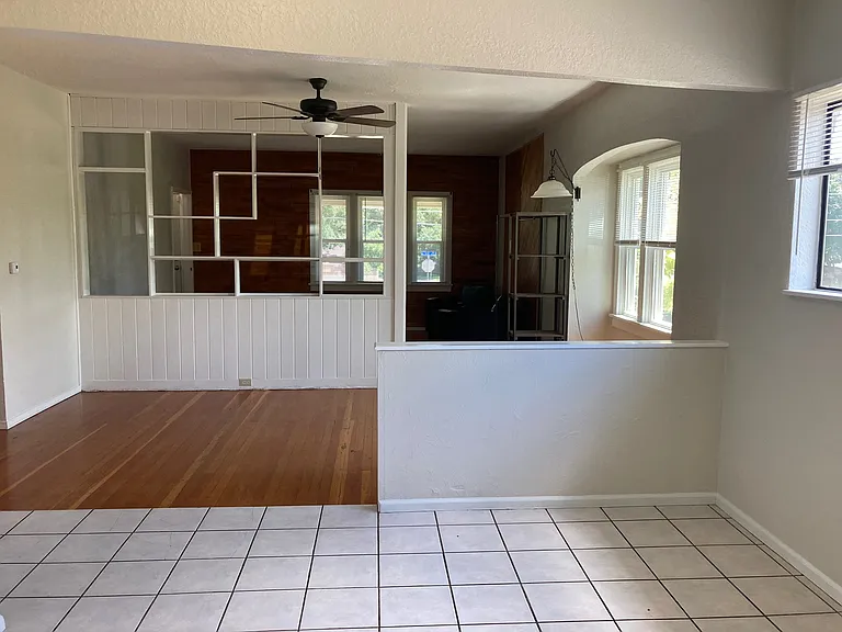 Looking out of the kitchen, you can see a spacious kitchen area for a table and chairs, as well as an additional area for a dining room table.