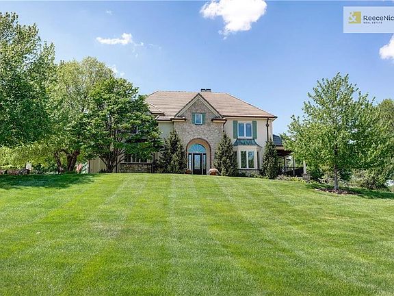 Stunning rare opportunity to own almost 3 acres and half of a pricate lake in the heart of Leawood.