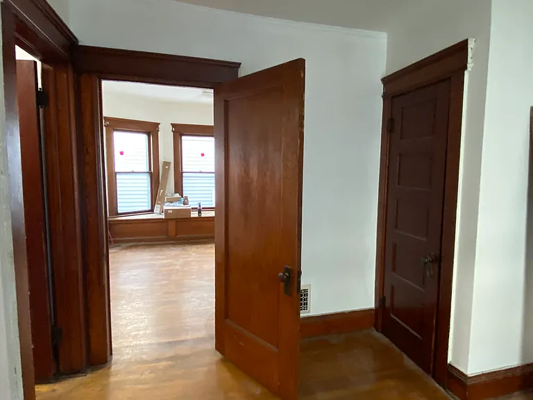 The historic five panel solid wood doors remain.