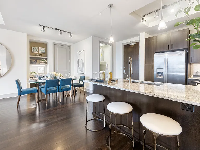 Open-concept floor plan with kitchen island, dining area and built-in dry bar