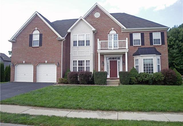 Brick & Stucco Colonial on landscaped lot
