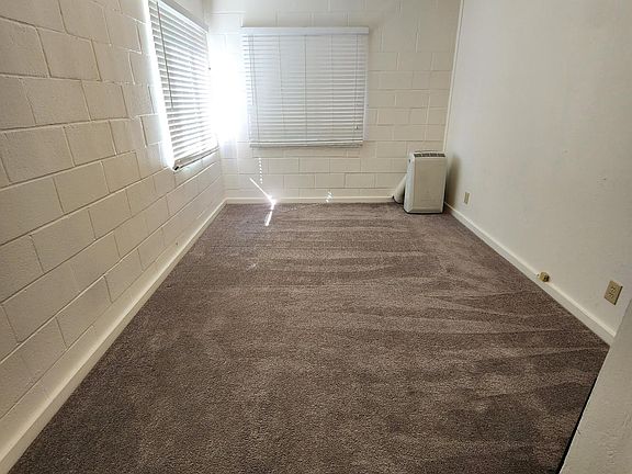 Bedroom looking west with portable air conditioner.