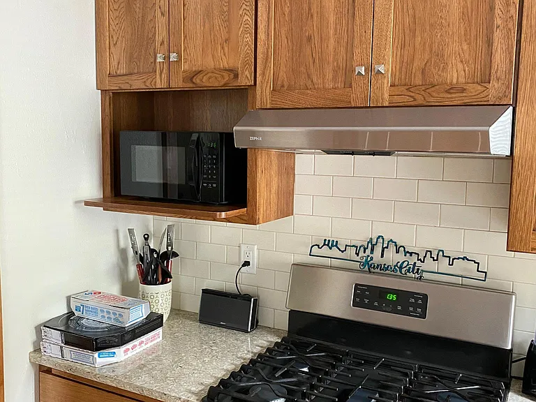 Ceramic white backsplash. Shelf for microwave.
