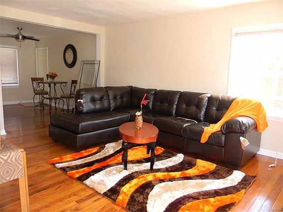 Living Room with refinished hardwood flooring and freshly painted.
