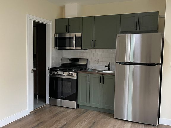 Brand new high quality kitchen appliances including microwave, oven, huge fridge with ample space