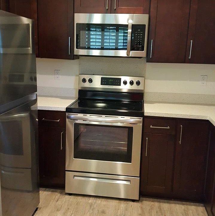 Brand new kitchen with stainless steel appliances.