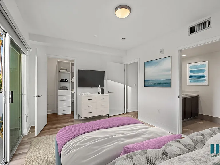 Bedroom with Walk-In Closet with Built-In Organizers, Bathroom, and Patio