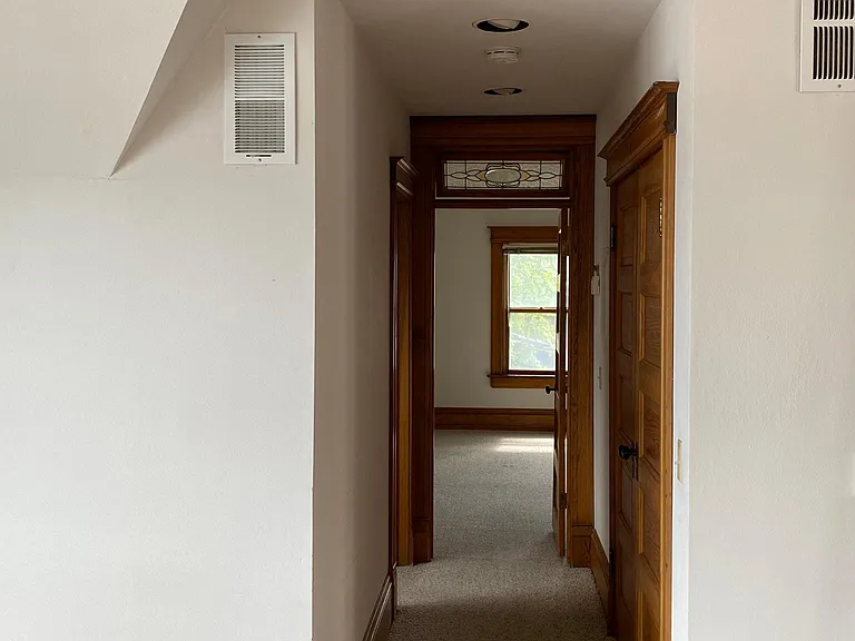 Hallway from LR to BR; laundry is behind doors on the right; bath on the left just before the BR
