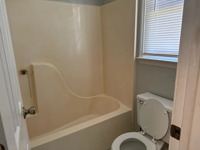 Bathroom off master bedroom has a single sink and the toilet and shower has a door to close. New flooring to be installed 10 July.